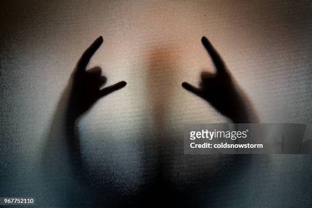 silhouette of heavy metal horn sign hand gesture - heavy metal stock pictures, royalty-free photos & images
