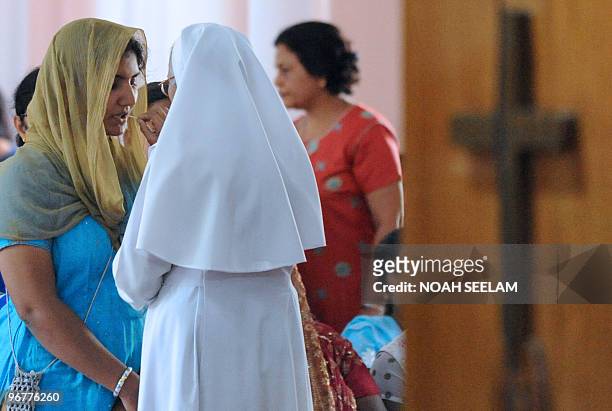 An Indian Catholic Christian receives The Holy Eucharist during an Ash Wednesday service at Saint Mary's Church in Secunderabad on February 17, 2010....