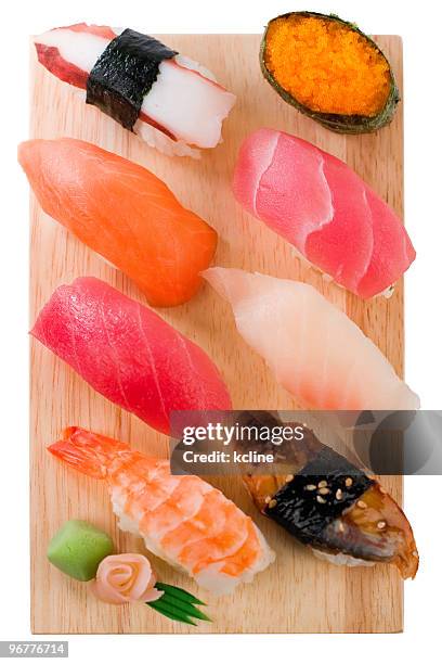 selection of sushi and sashimi on a wooden board - wasabi sauce stock pictures, royalty-free photos & images