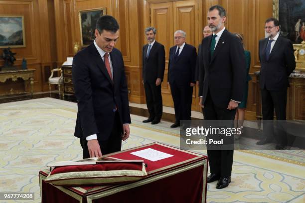 King Felipe VI of Spain looks on as Spain's new Prime Minister Pedro Sanchez takes the oath as President of the Spanish Constitutional Court Juan...