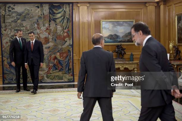 King Felipe VI of Spain, walks in with Spain's new Prime Minister Pedro Sanchez as and Former Prime Minister Mariano Rajoy walks into the other side...