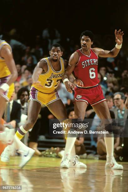 Magic Johnson of the Los Angeles Lakers defends Julius Erving of the Philadelphia 76ers on January 31, 1986 at The Forum in Inglewood, California....