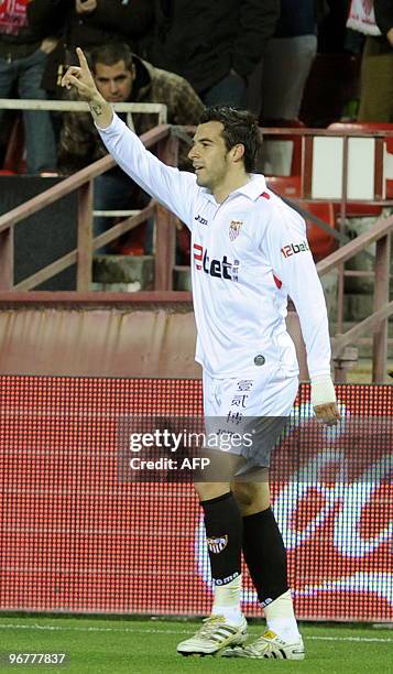 Sevilla's midfielder Alvaro Negredo celebrates after scoring against Valencia during a Spanish league football match at Sanchez Pizjuan stadium in...