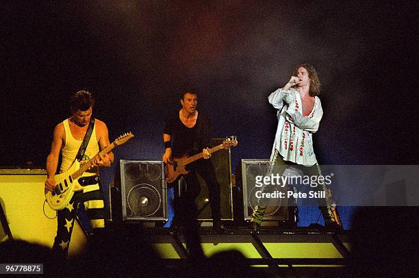 Tim Farriss, Garry Beers and Michael Hutchence of INXS perform on stage on the 'Kick' tour at Wembley Arena on June 24th, 1988 in London, United...