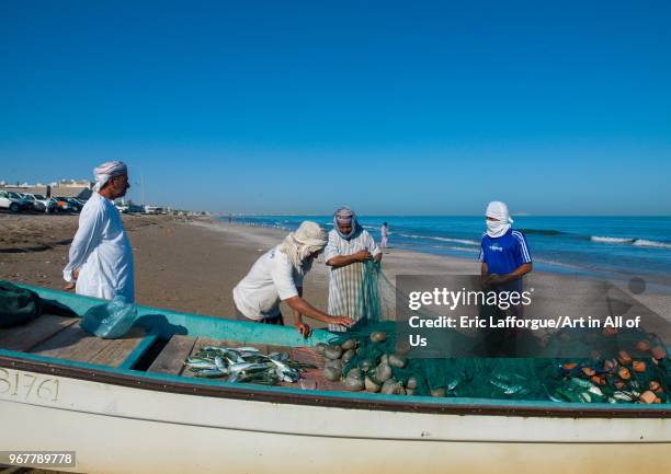 Fishermen bring back fishes in a boat on the beach, Al Batinah, Barka, Oman on December 21, 2011 in Barka, Oman.