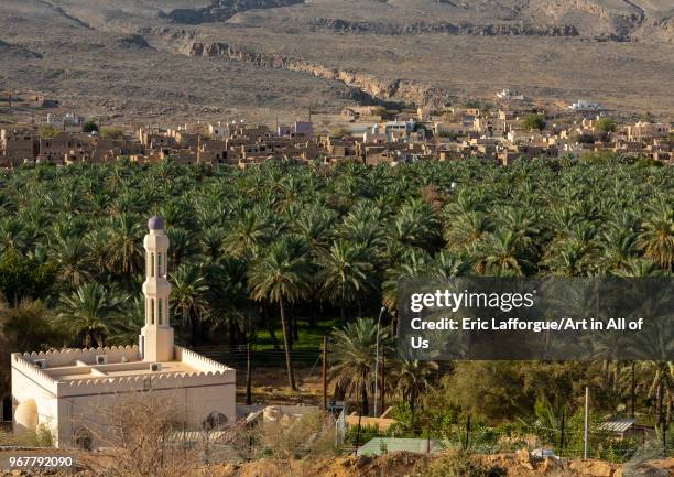 Mosque in front of an old village in an oasis, Ad Dakhiliyah Region, Al Hamra, Oman on May 10, 2018 in Al Hamra, Oman.