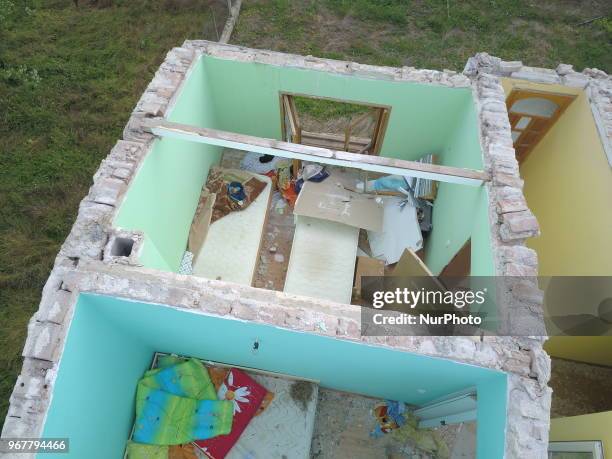 People observe destroyed by tornado home in the village of Kumanovo, east of the Bulgarian capital Sofia, Tuesday, June 2018. Heavy rains and storms...