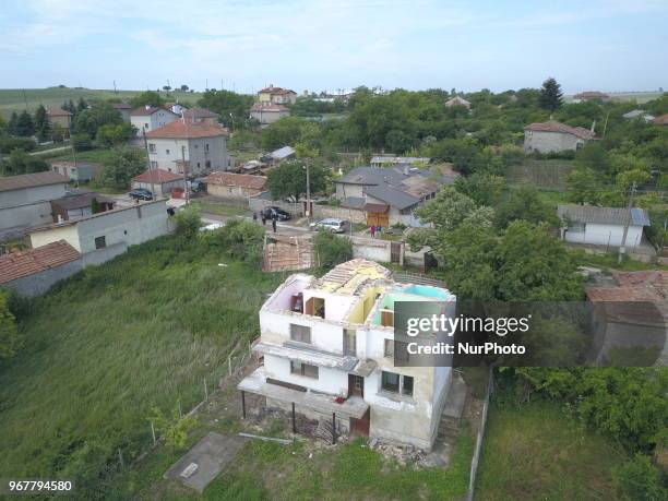 People observe destroyed by tornado home in the village of Kumanovo, east of the Bulgarian capital Sofia, Tuesday, June 2018. Heavy rains and storms...