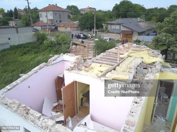 People observe destroyed by tornado home in the village of Kumanovo, east of the Bulgarian capital Sofia, Tuesday, June 2018. Heavy rains and storms...