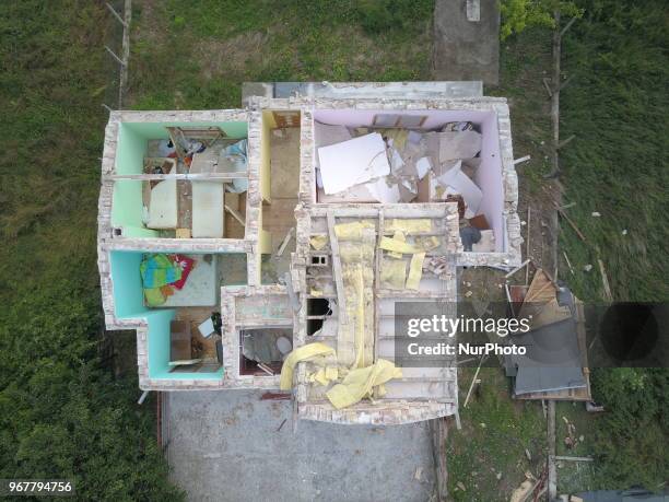 People observe destroyed by tornado home in the village of Kumanovo, east of the Bulgarian capital Sofia, Tuesday, June 2018. Heavy rains and storms...