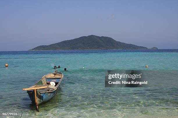 Fishing boat is moored on the beach at Chachauate on April 14 in the Cayos Cochinos, Honduras. The tiny but densely populated caye of Chachauate is...