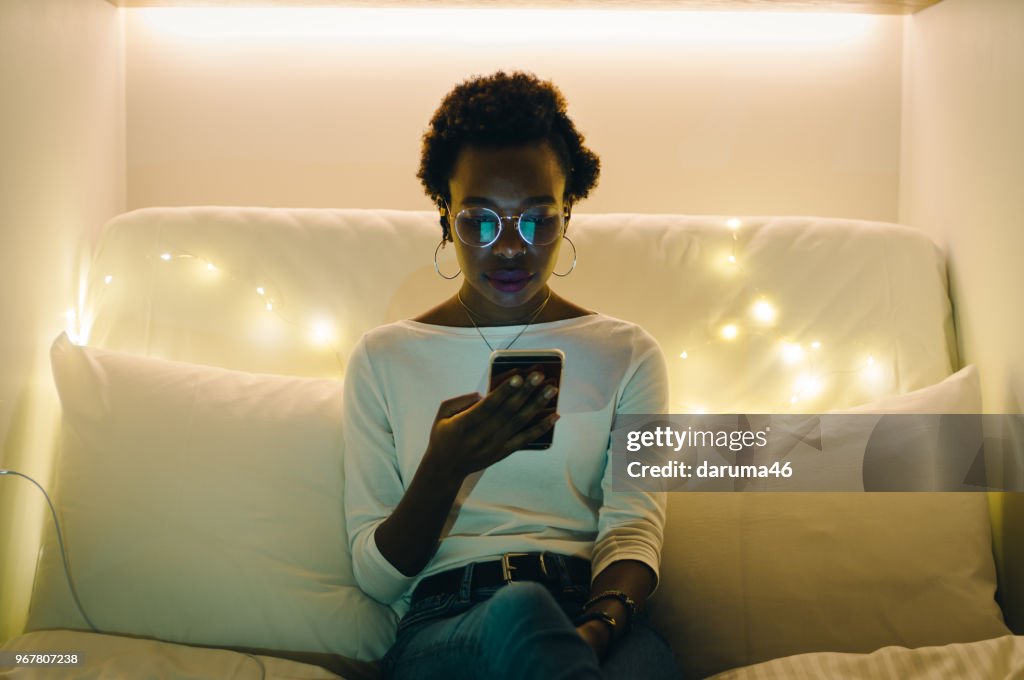Young women relaxing in bed.