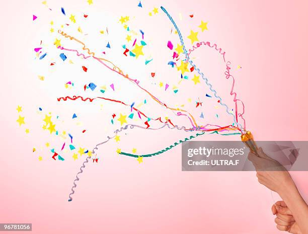 hands pulling a party popper. - party popper stockfoto's en -beelden