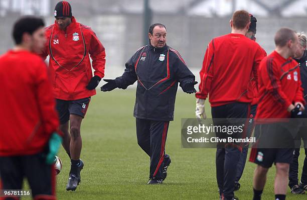 Liverpool manager Rafael Benitez speaks to his players during a training session prior to the UEFA Europa League round of 32 first-leg match between...