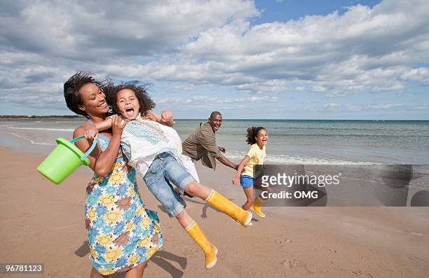 black family on the beach playing - northumberland foto e immagini stock