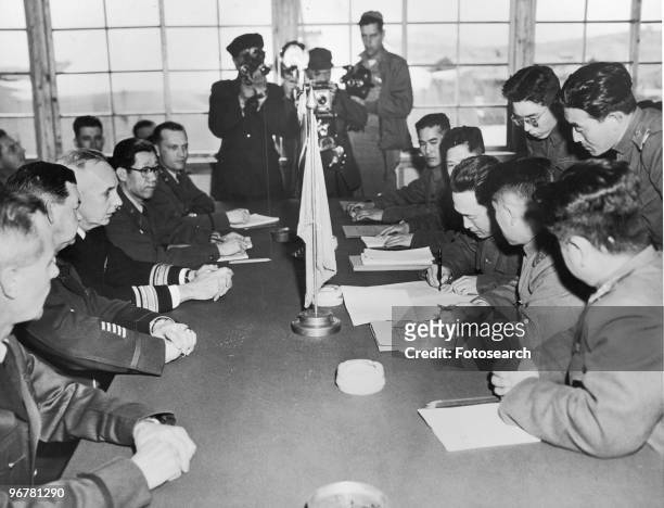 Photograph of North Korean Major General Lee Sang Jo Signing the Official Documents on Agreement of Exchanging Sick and Wounded Prisoners of War at...