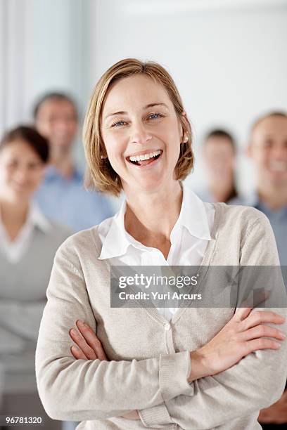 successful mature business woman laughing with col - adac stock pictures, royalty-free photos & images