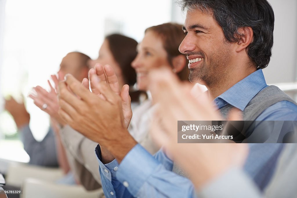 Happy business group of colleagues applauding 