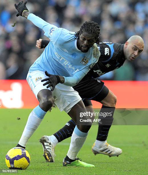 Manchester City's Togo forward Emmanuel Adebayor vies with Portsmouth's Anthony Vanden Borre during the English Premier League football match at The...