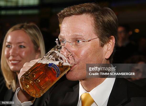German Foreign Minister and vice-chancellor Guido Westerwelle drinks beer during his party's Ash Wednesday meeting on February 17, 2010 in Straubing,...