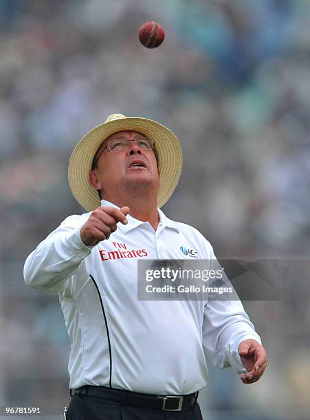 Umpire Ian Gould of England spins the ball during day four of the Second Test match between India and South Africa at Eden Gardens on February 17,...