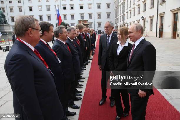 Russian President Vladimir Putin and Austrian President Alexander Van der Bellen look on BTB Group President Andrey Kostin during a welcoming...