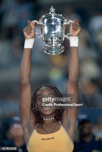 Venus Williams of the USA lifts the trophy after defeating Lindsay Davenport of the USA in the Women's Singles Final of the US Open at the USTA...