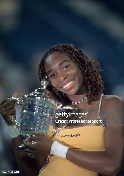 Venus Williams of the USA poses with the trophy after defeating Lindsay Davenport of the USA in the Women's Singles Final of the US Open at the USTA...