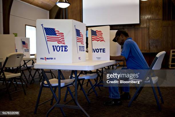 Voter fills out a ballot at a polling location in Davenport, Iowa, U.S., on Tuesday, June 5, 2018. Even as Donald Trump tweets his support for U.S....