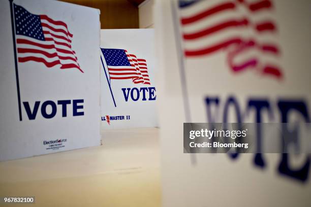 Privacy screens sit on a table at a polling location in Davenport, Iowa, U.S., on Tuesday, June 5, 2018. Even as Donald Trump tweets his support for...