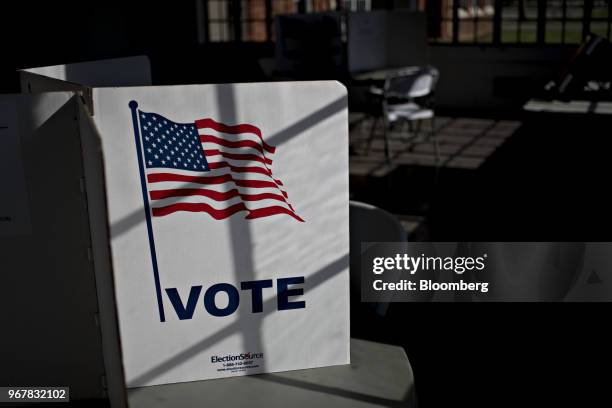 Voter privacy screen sits on a table at a polling station in Davenport, Iowa, U.S., on Tuesday, June 5, 2018. Even as Donald Trump tweets his support...