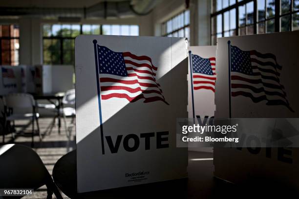 Voter privacy screens sit on a table at a polling station in Davenport, Iowa, U.S., on Tuesday, June 5, 2018. Even as Donald Trump tweets his support...