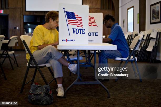 Voters fill out ballots at a polling location in Davenport, Iowa, U.S., on Tuesday, June 5, 2018. Even as Donald Trump tweets his support for U.S....