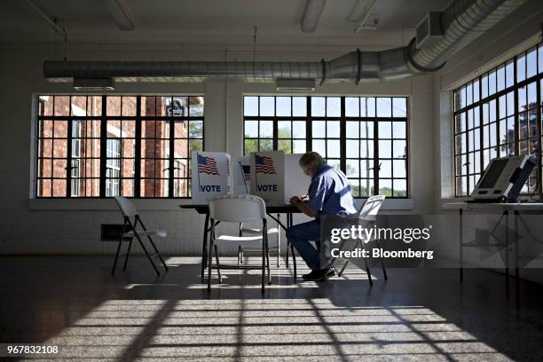 Voter fills out a ballot at a polling station in Davenport, Iowa, U.S., on Tuesday, June 5, 2018. Even as Donald Trump tweets his support for U.S....