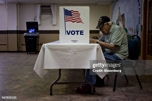 Voter fills out a ballot at a polling location in Davenport, Iowa, U.S., on Tuesday, June 5, 2018. Even as Donald Trump tweets his support for U.S....