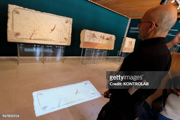 Visitor looks the exhibition 'L'Immagine Invisibile' at Archaeological Museum in Paestum southern Italy. The exhibition shows paintings, frescoes,...
