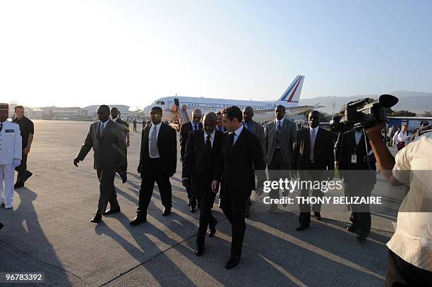 Haitian President Rene Preval and French President Nicolas Sarkozy speak moments after the French dignatary arrived in Port-Au-Prince on February 17,...