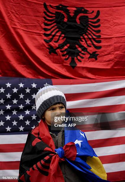 Kosovo Albanian child covered Kosovo and Albanian flags stands in the town of Mitrovica on February 17, 2010. Serbia will insist on fresh talks on...