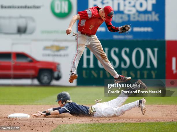 South Portland vs Portland baseball. Camren King of Portland steals second base in the fourth as Riley Hasson of South Portland has to leap for the...