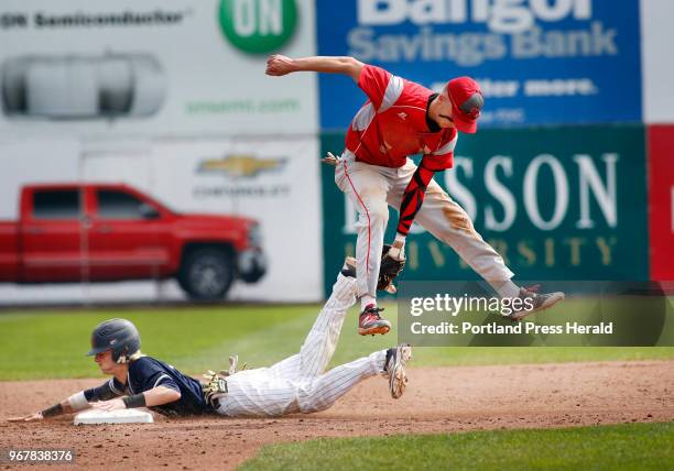 South Portland vs Portland baseball. Riley Hasson of South Portland tries to tag Camren King of Portland after he had to leap for the throw at second...