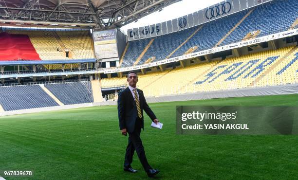 Turkish businessman and newly elected Fenerbahce chairman Ali Koc walks on the pitch during a gathering at the Ulker Stadium in Istanbul on June 5 in...