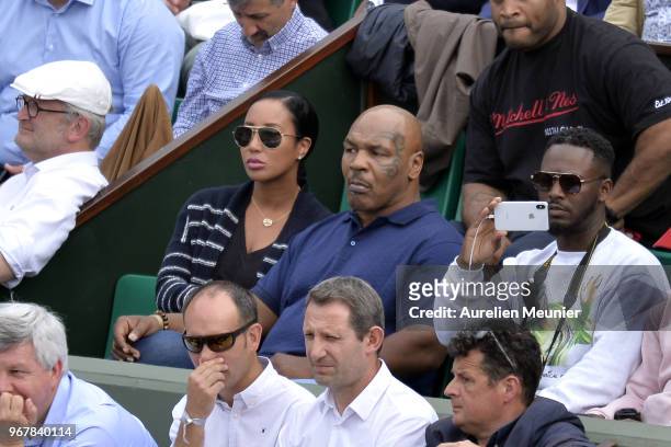 Former heavyweight boxing world champion Mike Tyson and his wife Kiki Tyson attend the women's singles quaterfinal match between Daria Kasatkina of...