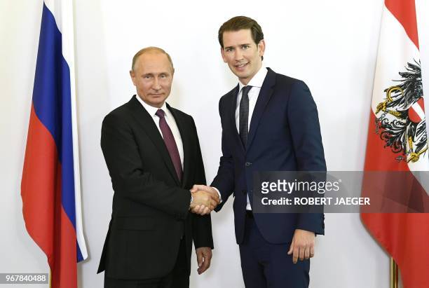 Russian President Vladimir Putin and Austrian Chancellor Sebastian Kurz shak hands in Vienna, Austria, June 5, 2018. - President Putin is on a...
