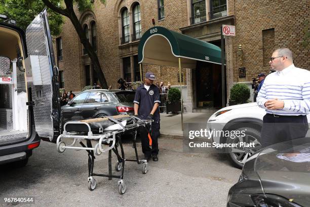 City workers enter a building to retrieve the body of fashion designer Kate Spade who was found dead in her apartment of an apparent suicide on June...