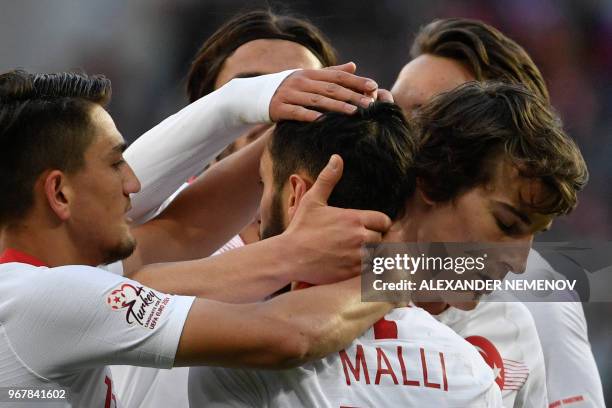 Turkey's Yunus Malli celebrates with teammates after scoring a goal during an international friendly football match between Russia and Turkey at...
