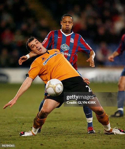 Wolverhampton Wanderers' Serbian midfielder Nenad Milijas vies with Crystal Palace's English defender Clint Hill during their FA Cup fourth round...