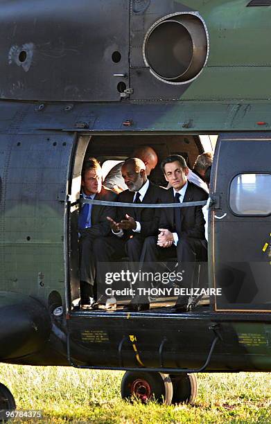 Haitian President Rene Preval sits with French President Nicolas Sarkozy and French Foreign Minister Bernard Kouchner as they get ready to survey the...
