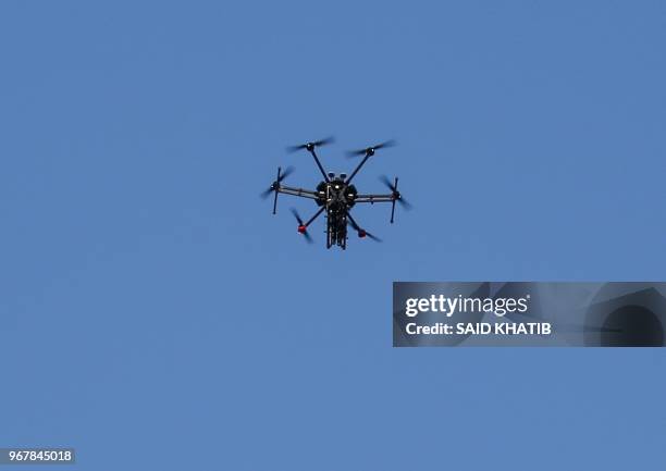 Picture taken on June 5, 2018 shows an Israeli quadcopter drone flying over Palestinian demonstrations near the border with Israel east of Khan Yunis...