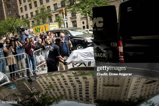 City workers carry the body of fashion designer Kate Spade out of her apartment building after she was found dead of an apparent suicide on June 5,...