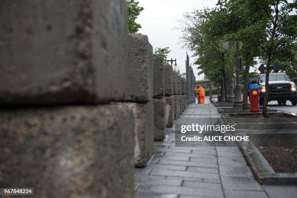 Brick and wire fence is erected at the International Media Centre in Quebec City on June 5 in preparation for the G7 Summit. - Attention this week...